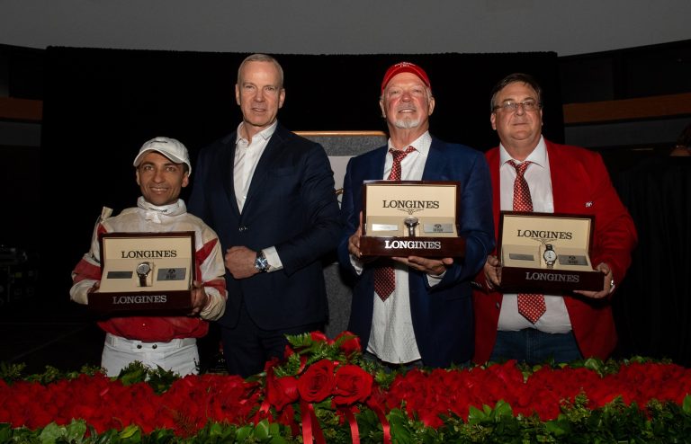 Matthias Breschan, second left, Longines CEO, presents Longines Master Collection timepieces to owner Richard Dawson, second right, trainer Eric Reed, right, and jockey Sonny Leon after their horse Rich Strike won the 148th running of the Kentucky Derby on Saturday, May 7, 2022, at Churchill Downs in Louisville, KY. Imagery courtesy of Diane Bondareff/AP Images for Longines