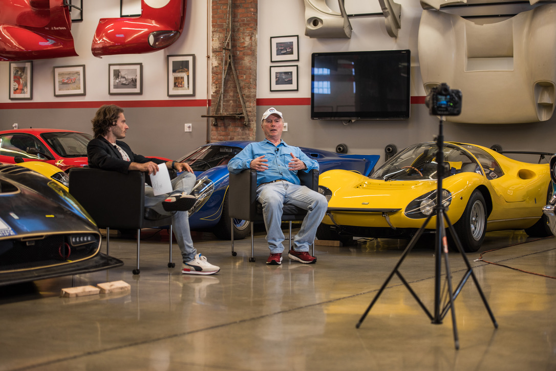 A filmed interview in a collection of sports and racing cars